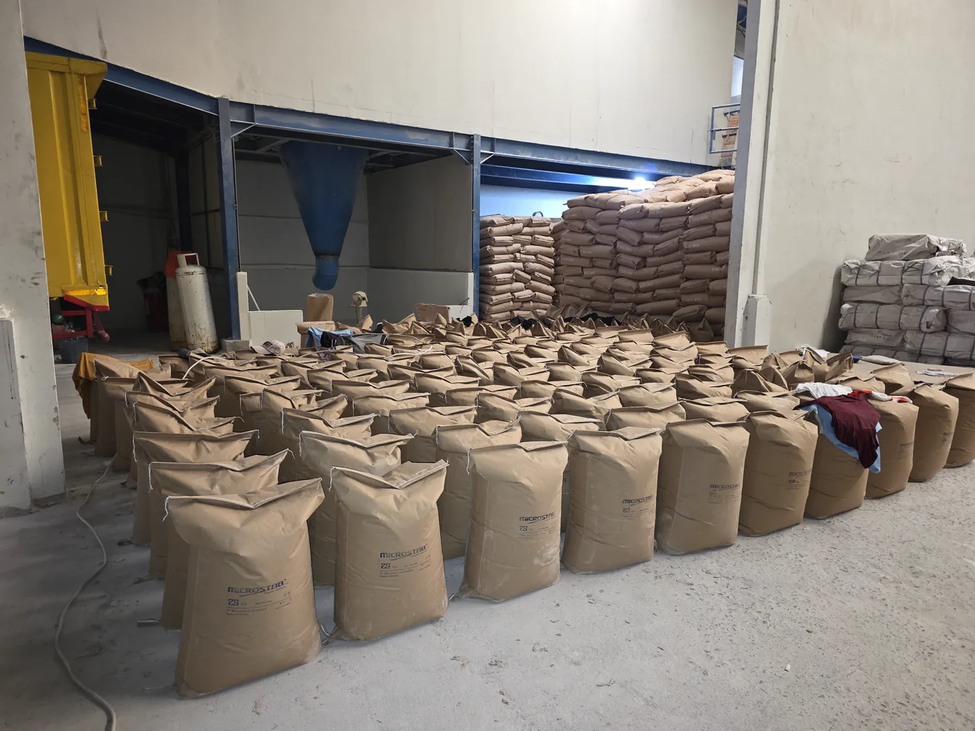 Open industrial bags arranged near warehouse handling equipment
