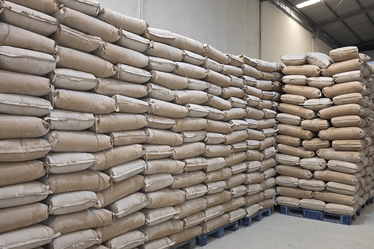 Rows of palletized industrial additive bags stored in a warehouse