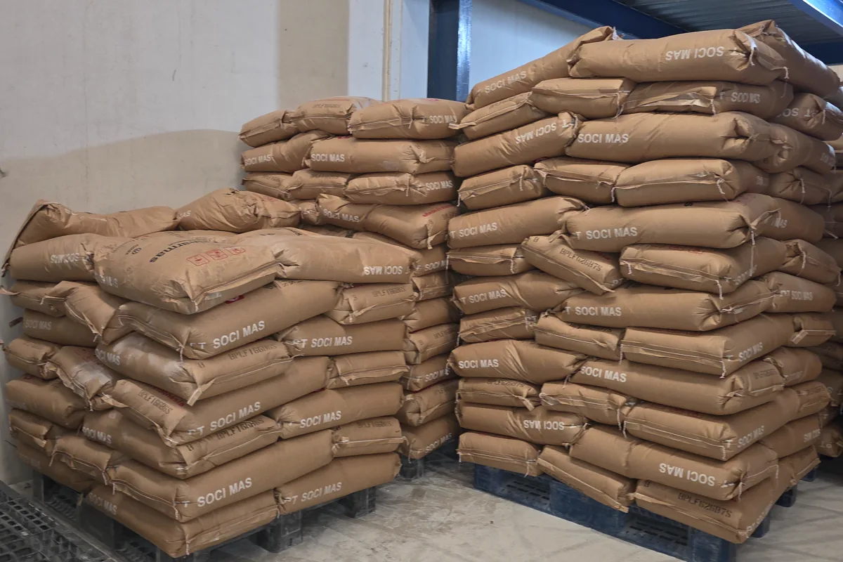Two groups of palletized industrial material bags in warehouse storage